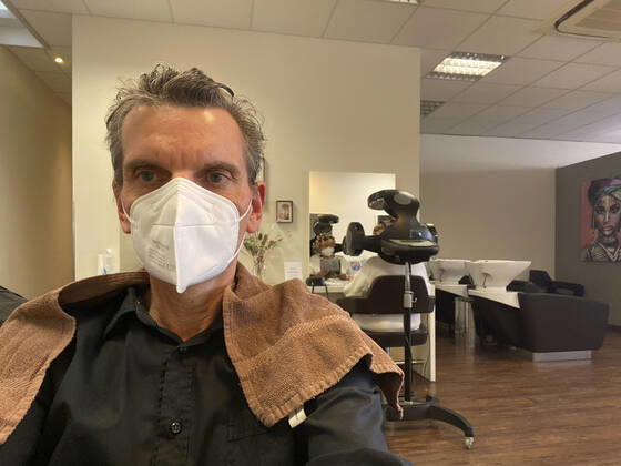 Customer with FFP2 mask and wet hair at hairdresser, hair salons open during lockdown, Corona crisis, Stuttgart, Baden Württemberg, Germany Coronavirus
