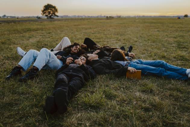Young male and female friends lying on grass in park Germany, Berlin, model released Copyright: xMaskotx , MA84315
