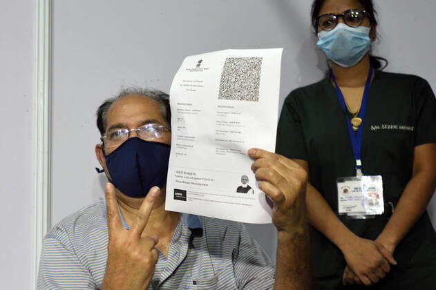 MUMBAI, INDIA - MARCH 1: A senior citizen holding up a registration slip during inoculation to get their first dose of a Covid-19 vaccine, at BKC on March 1, 2021 in Mumbai, India. India?s Covid-19 vaccination drive was extended today to include the elderly and those with co-morbidities. (Photo by Satish Bate Hindustan Times) Covid Vaccination Phase 2 Starts In India