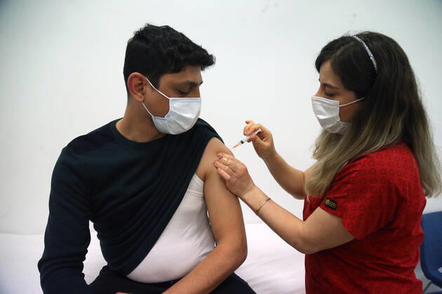 (210302) -- ANKARA, March 2, 2021 -- A man receives the COVID-19 vaccine in Ankara, Turkey on March 1, 2021. Turkey on Monday reported 9,891 new COVID-19 cases, including 645 symptomatic ones, raising the total number in the country to 2,711,479, according to the health ministry. The country started mass vaccination for COVID-19 on Jan. 14 after the authorities approved the emergency use of the Chinese CoronaVac vaccine. About 7,046,000 people have been vaccinated so far. (Photo by Xinhua) TURKEY-ANKARA-COVID-19-VACCINATION MustafaxKaya