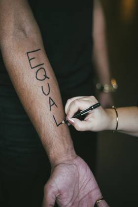 Female activist writing on man s hand for social issues Sweden, Stockholm, model released Copyright: xMaskotx , MA84426