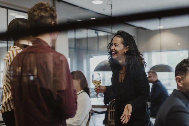 Cheerful female and male colleagues talking in company during party Sweden, Stockholm, model released, property released Copyright: xMaskotx , MA84661