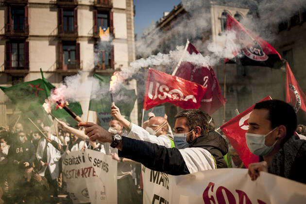 March 10, 2021, Barcelona, Spain: Healthcare workers protest amid smoke as they gather in Barcelona to demand an improvement in their working conditions aggravated by the coronavirus pandemic. Barcelona Spain - ZUMAb137 20210310_zap_b137_002 Copyright: xJordixBoixareux