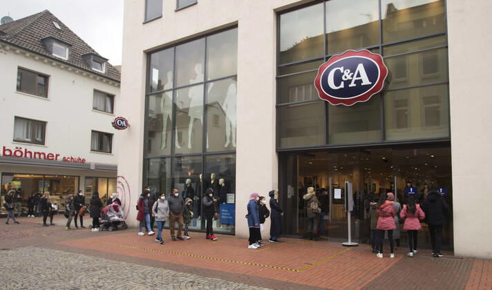 The Moers city centre in Corona times View of the Moers pedestrian zone in Corona times Queues of shoppers form in front of the textile department store C A Moers Germany North Rhine Westphalia
