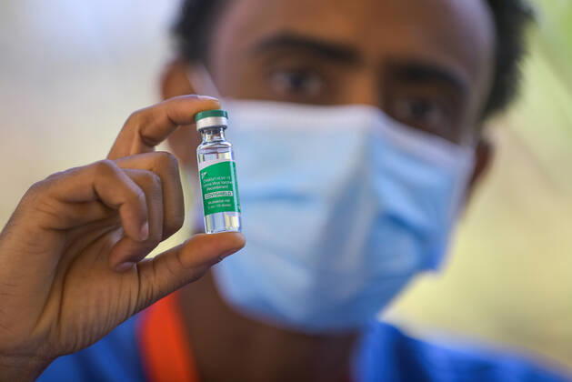 (210313) -- ADDIS ABABA, March 13, 2021 -- A medical worker shows a vial of the COVID-19 vaccine in Addis Ababa, Ethiopia, on March 13, 2021. Ethiopian State Minister of Health Dereje Duguma disclosed on Saturday that the east African country plans to give COVID-19 vaccine jabs to 20 percent of its population by March 2022. Duguma disclosed the plan during a ceremony in Addis Ababa to officially start COVID-19 vaccine jabs in the country. ) ETHIOPIA-ADDIS ABABA-COVID-19 VACCINATION-START MichaelxTewelde 