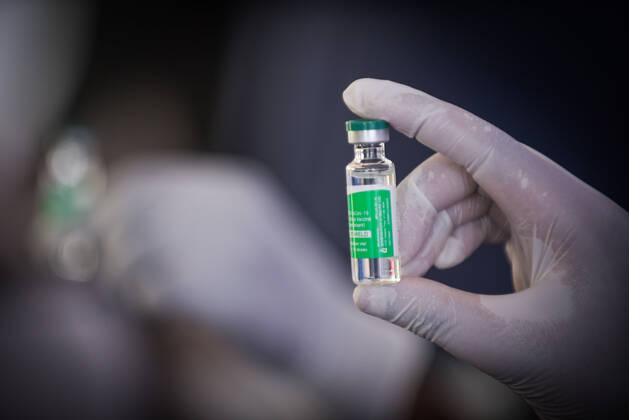 (210313) -- ADDIS ABABA, March 13, 2021 -- A medical worker shows a vial of the COVID-19 vaccine in Addis Ababa, Ethiopia, on March 13, 2021. Ethiopian State Minister of Health Dereje Duguma disclosed on Saturday that the east African country plans to give COVID-19 vaccine jabs to 20 percent of its population by March 2022. Duguma disclosed the plan during a ceremony in Addis Ababa to officially start COVID-19 vaccine jabs in the country. ) ETHIOPIA-ADDIS ABABA-COVID-19 VACCINATION-START MichaelxTewelde 