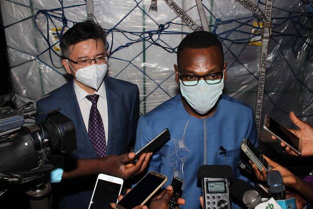 (210322) -- COTONOU, March 22, 2021 -- Benin s Health Minister Benjamin Hounkpatin and Chinese Ambassador to Benin Peng Jingtao attend a reception ceremony of a batch of coronavirus vaccine developed by the Chinese pharmaceutical company Sinovac at Cardinal Bernadin Gantin International Airport in Cotonou, Benin, March 21, 2021. A batch of coronavirus vaccine developed by the Chinese pharmaceutical company Sinovac arrived in Cotonou, the economic capital of Benin, on Sunday evening. (Photo by Xinhua) BENIN-COTONOU-CHINESE VACCINE-ARRIVAL SeraphinxZounyekpe 