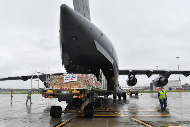 AUSMAT VACCINE PNG COVID19 RESPONSE, Royal Australian Air Force personal are seen loading COVID-19 vaccines and humanitarian supplies onto a C-17A Globemaster at RAAF Base Amberley, west of Brisbane, Tuesday, March 23, 2021. Australia are sending 8,000 doses of its COVID-19 vaccine supply to Papua New Guinea who have more than 1,400 active cases of COVID-19 and the Australian government are asking AstraZeneca and European authorities to divert another 1 million doses to Papua New Guinea. ( NO ARCHIVING, EDITORIAL USE ONLY, NO USE IN BOOKS WITHOUT CONSENT BRISBANE QLD AUSTRALIA  Copyright: xDARRENxENGLANDx 20210323001529485240