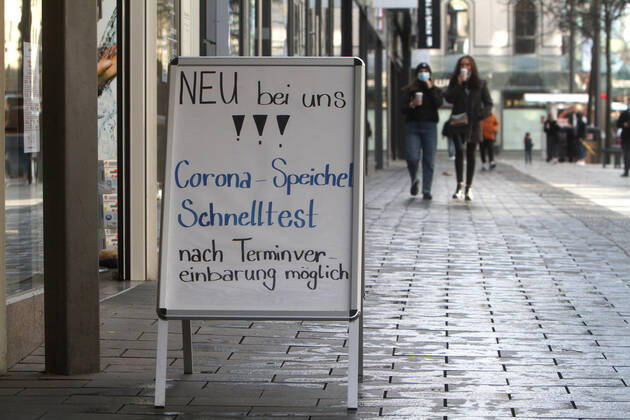 Stand with inscription new with us, Corona saliva quick test after appointment arrangement possibly stands before a pharmacy in the pedestrian precinct and shopping street Planken in the city center of Mannheim, Baden Wuerttemberg, Germany
