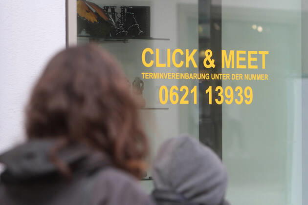 Lettering Click Meet book your personal shopping appointment is stuck in a shop window of a fashion store in the pedestrian zone and shopping street Planken in downtown Mannheim, Baden Württemberg, Germany