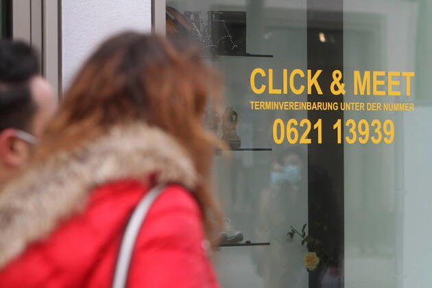 Lettering Click Meet book your personal shopping appointment is stuck in a shop window of a fashion store in the pedestrian zone and shopping street Planken in downtown Mannheim, Baden Württemberg, Germany