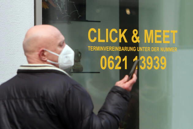 Lettering Click Meet book your personal shopping appointment is stuck in a shop window of a fashion store in the pedestrian zone and shopping street Planken in downtown Mannheim, Baden Württemberg, Germany
