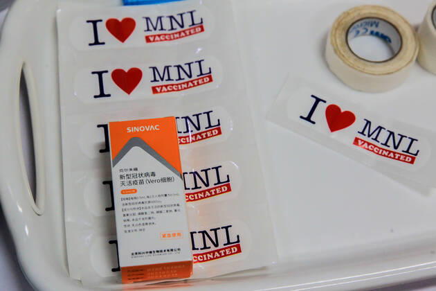 (210331) -- MANILA, March 31, 2021 -- A box of Sinovac vaccine is seen on stickers to be used as signs after vaccination at a vaccination site in Manila, the Philippines on March 31, 2021. The Philippines Department of Health (DOH) reported on Wednesday 6,128 new COVID-19 infections, bringing the total number of confirmed cases in the Southeast Asian country to 747,288. ) PHILIPPINES-MANILA-COVID-19-SINOVAC VACCINES RouellexUmali 