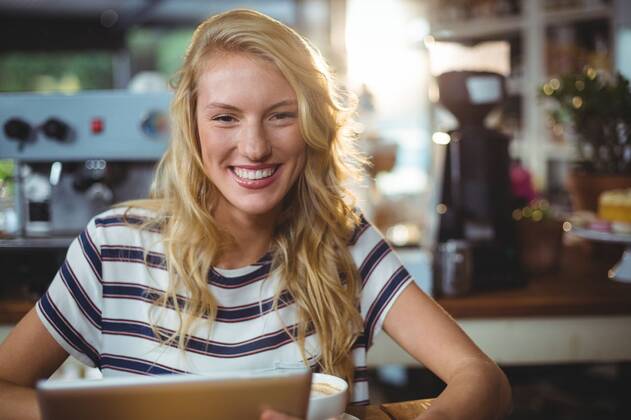 Woman sitting in a cafe using digital tablet Portrait of woman sitting in a cafe using digital tablet, model released, , property released, Cape Town, South Africa, 30.05.2016, 797483.jpg, table, cafe, coffee shop, cafeteria, restaurant, hotel, casual clothing, sitting, holding, smiling, cheerful, web, internet, touching, reading, scrolling, digital tablet, tablet computer, tablet pc, touchscreen, wireless technology, communication, connection, happy, lifestyle, leisure, pretty, attractive Indoors,Portrait,Looking at camera,Day
