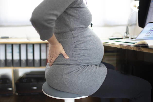 Young pregnant woman in pain at work Bonn Germany Copyright: xUtexGrabowsky photothek.netx