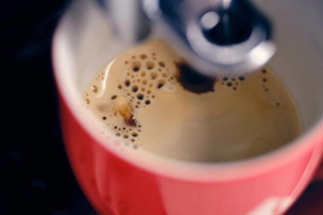 Vienna, Austria April 17, 2021 Red cup under a coffee machine is filled Vienna Vienna Austria