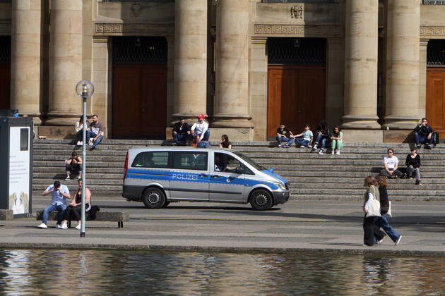 A police patrol of the state police Baden Württemberg controls the observance of the minimum distances at the Eckensee in front of the state theatre in the city centre of Stuttgart, Baden Württemberg, Bavaria, Germany