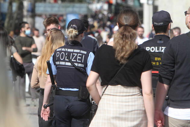 A police patrol of the state police Baden Württemberg controls the compliance with the minimum distances in the pedestrian zone and shopping street Königstraße in the city centre of Stuttgart, Baden Württemberg, Bavaria, Germany