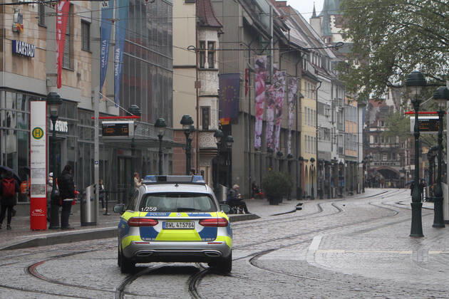 A police patrol of the state police of Baden Württemberg drives through the almost deserted pedestrian zone and shopping street Kaiser Joseph Straße in the city center of Freiburg, Baden Württemberg, Bavaria, Germany.