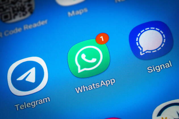 Logos of the social media messenger apps Telegram, WhatsApp and Signal on the screen of a smartphone