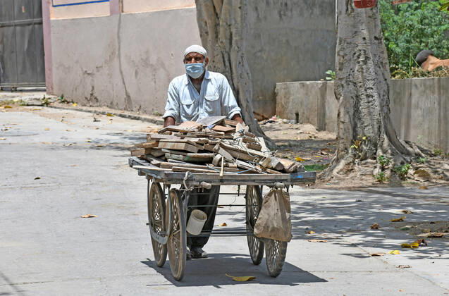 Cremation Of COVID-19 Victims In Rajasthan, India A worker pulls a handcart loaded with firewood for cremation of COVID-19 victim at Hindu Moksha Dham Crematorium in Beawar. Beawar Rajasthan India Copyright: SumitxSaraswat