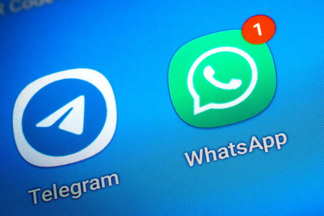 Logos of the social media messenger apps Telegram and WhatsApp on the screen of a smartphone