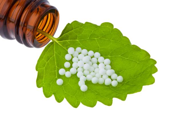 Homeopathy globules as alternative medicine lying on a sheet McPBBO McPBBO