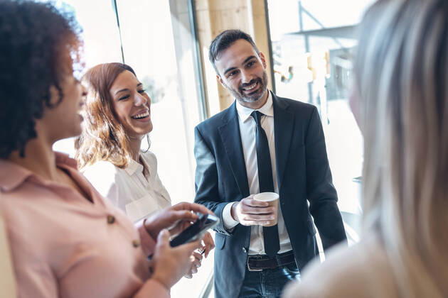 Smiling male professional with coworkers in office model released Symbolfoto property released JSRF01544