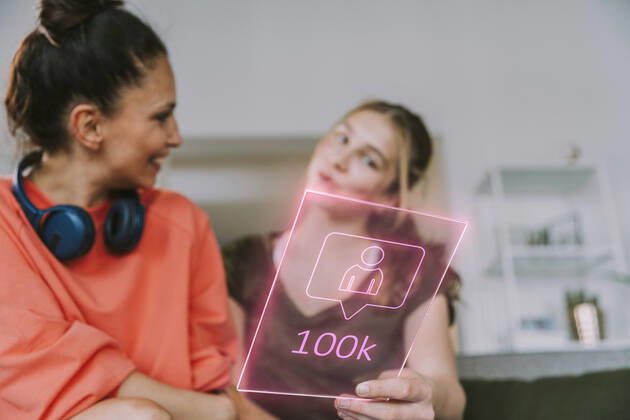 Female influencers discussing over 100k followers on social media at home model released Symbolfoto property released LIFIF00039