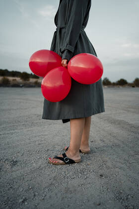 Woman holding balloon while standing at road model released Symbolfoto RCPF01006