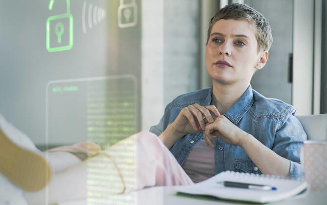 Businesswoman looking at data security system at office model released Symbolfoto property released UUF23645