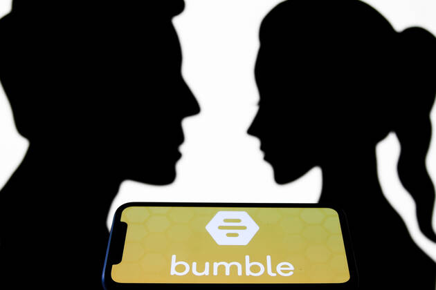 Dating Apps Photo Illustrations Bumble logo displayed on a phone screen is seen with paper silhouettes looking like a man and a woman in this illustration photo taken in Krakow, Poland on July 31, 2021. Krakow Poland porzycki-datingap210731_npmC9  Copyright: xJakubxPorzyckix