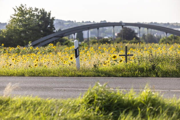 A cross at the roadside commemorates a victim of road traffic 12 08 2021 Germany, Baden Württemberg, Rottenburg am Neckar