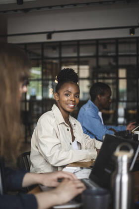 Portrait of smiling female hacker in office Sweden, Stockholm, model released, property released Copyright: xMaskotx , MA87934