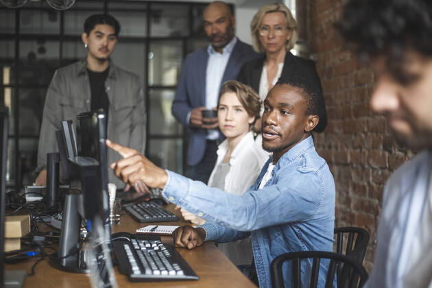 Male computer programmer discussing with investors at office Sweden, Stockholm, model released, property released Copyright: xMaskotx , MA87982