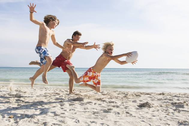 Boy and father chasing brother with rugby ball on beach, Majorca, Spain, 13.04.2016, Copyright: xRUSSxROHDEx, model released, chasing,wearing,running,jumping,playing,adolescence,childhood,determination,carefree,competition,fun,innocence,sharing,togetherness,vitality,friendship,rugby ball,in a row,25 to 29 years,child,10 to 11 years,teenager,male,boy,teenage boy,man,young man,three people,spain,majorca,outdoors,coast,beach,sea,summer,action,swimming trunks,energy,son,father,brother,lifestyle,sunlight,leisure,travel,vacation,blue sky,family life,mid air,travel destination,13 to 14 years,enjoyment,only male,male bonding,April 2016 Release,ruby,Jumping,Moving After,Chasing,Playing,Running,Young Adult,25-29 Years,Child,Pre-Adolescent Child,10 Ref:IS09AX1DV
