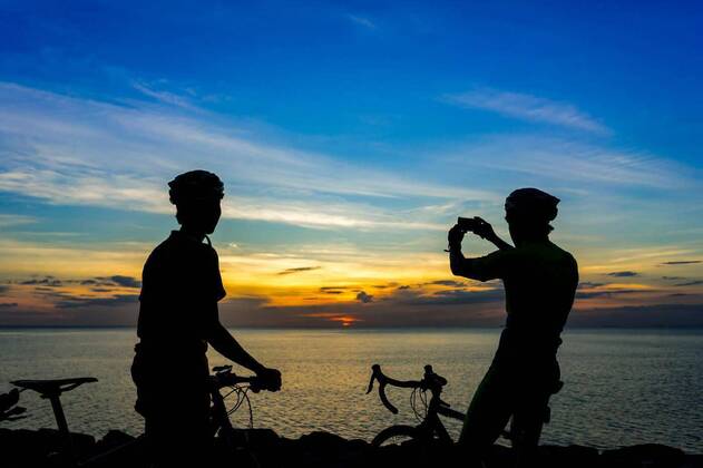 IMAGO Creative: Sommer Sport - Strand  Cyclists with bicycles at the beach, at dusk., 12.10.2020, Copyright: xlittlekopx Panthermedia26077640