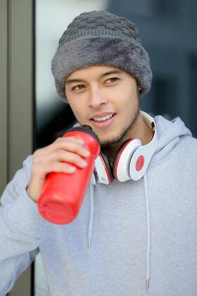  Smiling young latin man drinking water portrait format winter sports training fitness model released, Symbolfoto, 13.10.2020, Copyright: xBoarding_Nowx Panthermedia27289279
