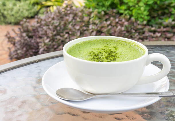 Closeup a cup of matcha latte or green tea on glass table with nature background Copyright: xx 24985618