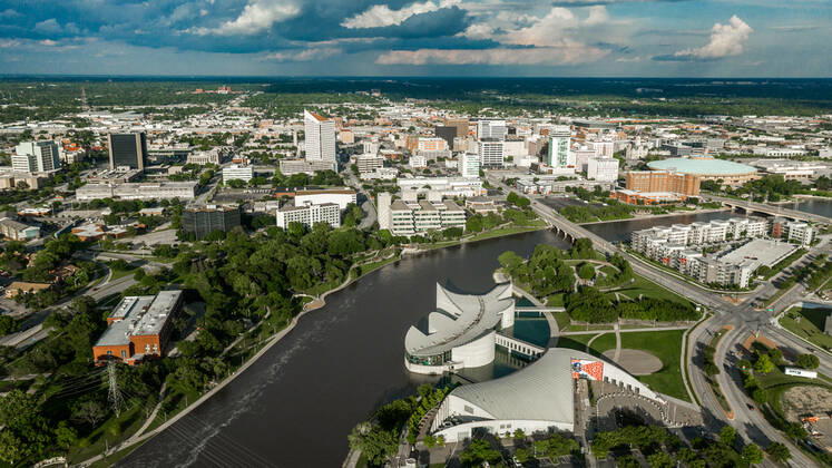 Drone aerial view of downtown Wichita Skyline, Kansas features Exploration Place on Arkansas River. copyrightxjoexsohmx2021xallxrightsxreserved 929_14_voahd-80-652