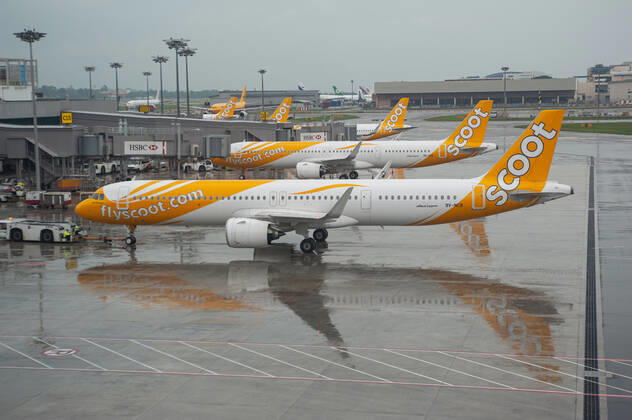 15 11 2021, Singapore, Republic of Singapore, Asia A Scoot Airlines Airbus A321neo passenger aircraft with registration 9V NCB during pushback at Changi International Airport with parked aircraft in the background Scoot is a Singapore-based low-cost airline and a subsidiary of Singapore Airlines