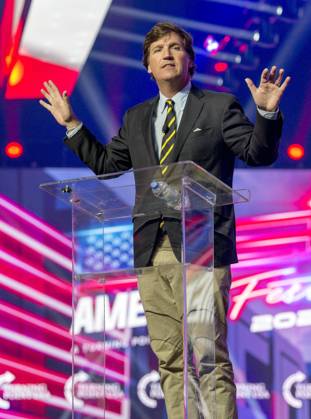 December 19, 2021 - Phoenix, Arizona, USA - Fox News host TUCKER CARLSON speaks at AmericaFest, a Turning Point USA event. Phoenix USA - ZUMAce6_ 20211219_zaf_ce6_016 Copyright: xBrianxCahnx