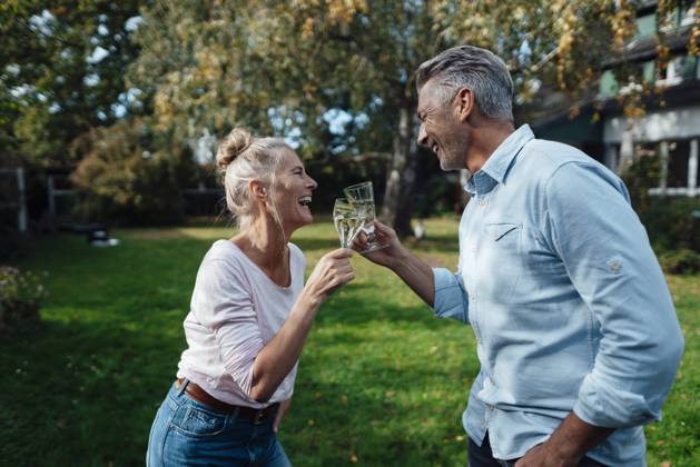 Happy couple toasting champagne flute at backyard model released property released, JOSEF06206