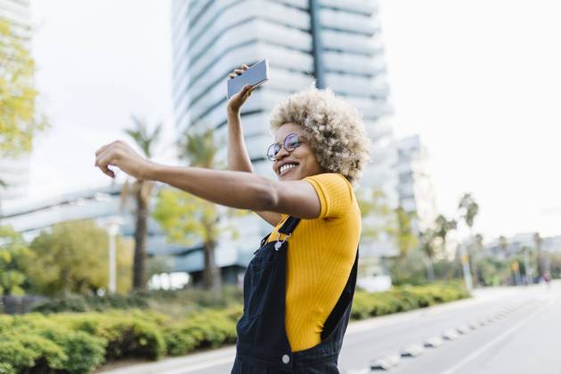 Woman holding mobile phone and dancing on road model released, XLGF02462