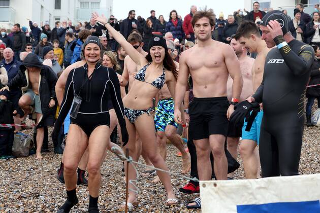 Over 350 New Year revellers, many in fancy dress, take part in the New Year Big Dip at East Wittering Beach in Chichester, West Sussex. More than double the previous record number of people took part, making the most of the warmest New YearÕs Day on record in the UK. JANUARY 1st 2022  MTXx2201