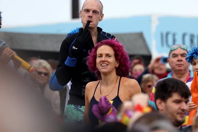 Over 350 New Year revellers, many in fancy dress, take part in the New Year Big Dip at East Wittering Beach in Chichester, West Sussex. More than double the previous record number of people took part, making the most of the warmest New YearÕs Day on record in the UK. JANUARY 1st 2022  MTXx2201