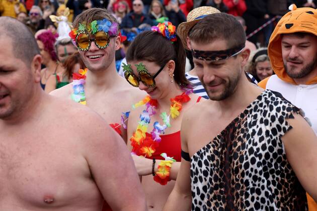 Over 350 New Year revellers, many in fancy dress, take part in the New Year Big Dip at East Wittering Beach in Chichester, West Sussex. More than double the previous record number of people took part, making the most of the warmest New YearÕs Day on record in the UK. JANUARY 1st 2022  MTXx2201