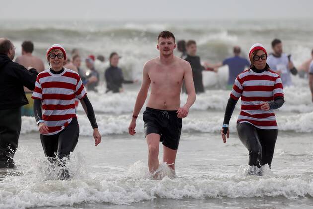 Over 350 New Year revellers, many in fancy dress, take part in the New Year Big Dip at East Wittering Beach in Chichester, West Sussex. More than double the previous record number of people took part, making the most of the warmest New YearÕs Day on record in the UK. JANUARY 1st 2022  MTXx2201