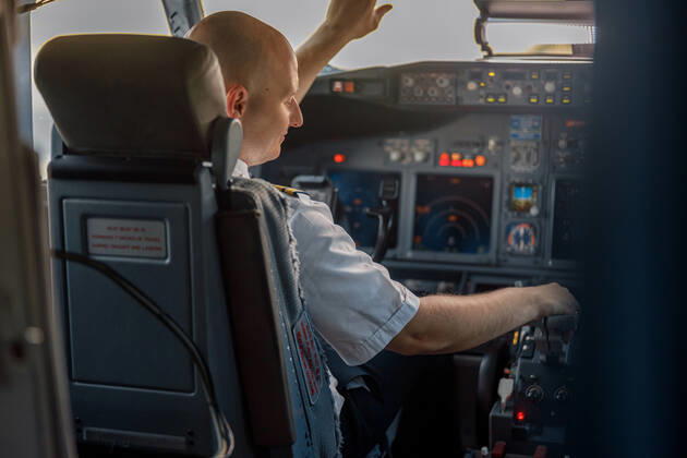 Focused professional pilot sitting in an airplane cabin, ready for takeoff Focused professional pilot sitting in an airplane cabin, ready for takeoff. Aircraft, aircrew, occupation concept Copyright: xyaroslavxastakhovx 40764190