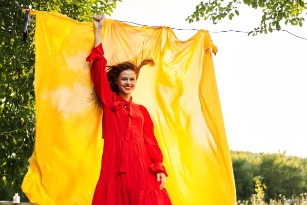 woman in a red dress with hands raised up yellow fabric nature woman in a red dress with hands raised up yellow fabric nature. High quality photo Copyright: xx 41065668
